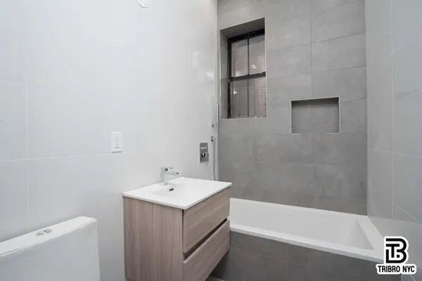 a bathroom with a sink a toilet and bathtub