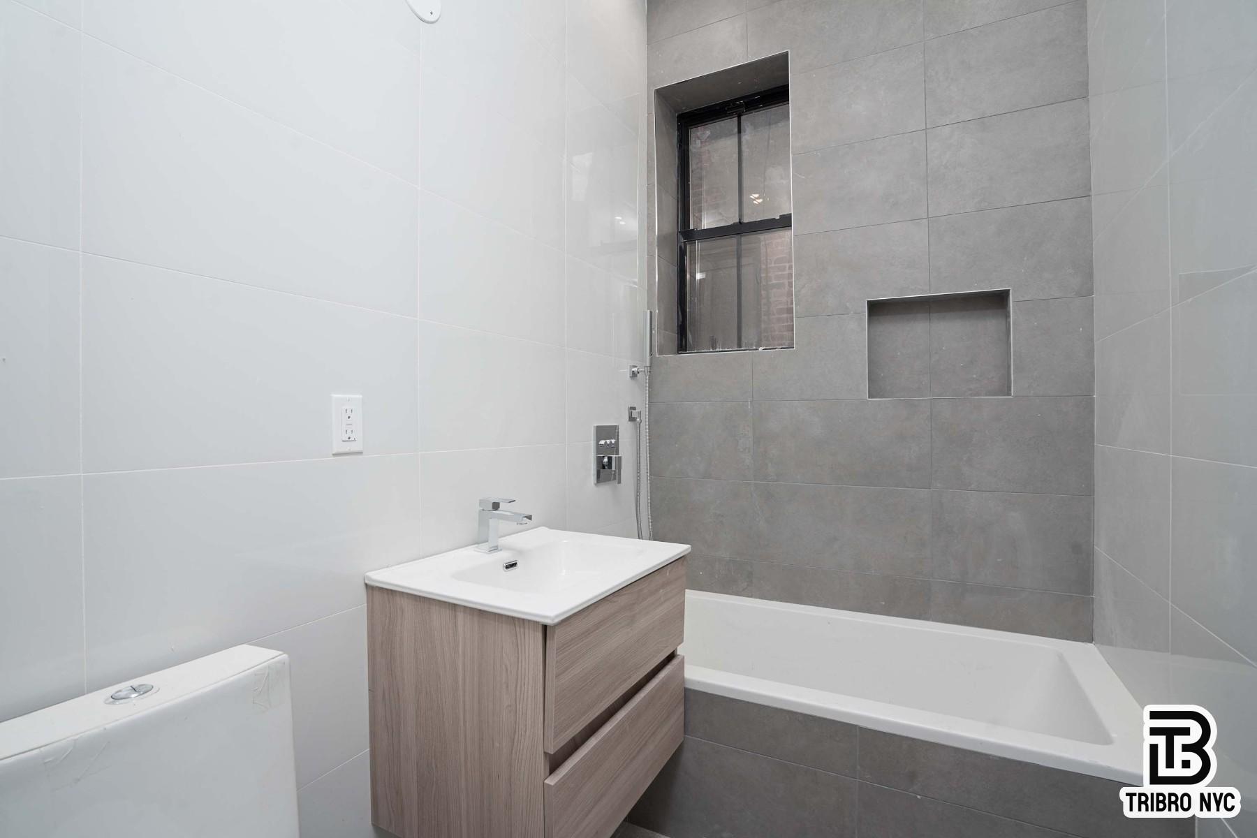 62-15 Catalpa Avenue, Unit 3A Queens, NY 11385 - Photo 7 of 9 a bathroom with a sink a toilet and bathtub