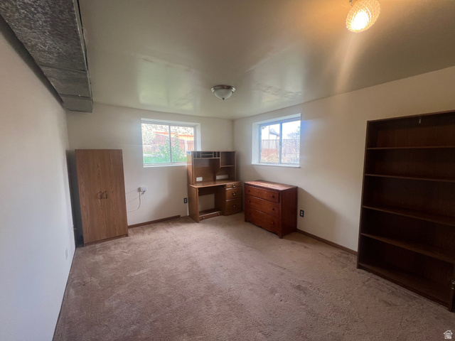 819 Castle Gate Circle Helper, UT 84526 - Photo 26 of 36 Unfurnished bedroom with light colored carpet and baseboards