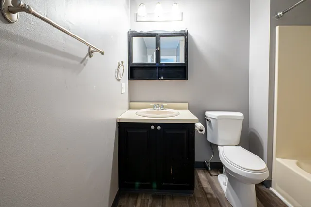 a bathroom with a sink toilet and shower