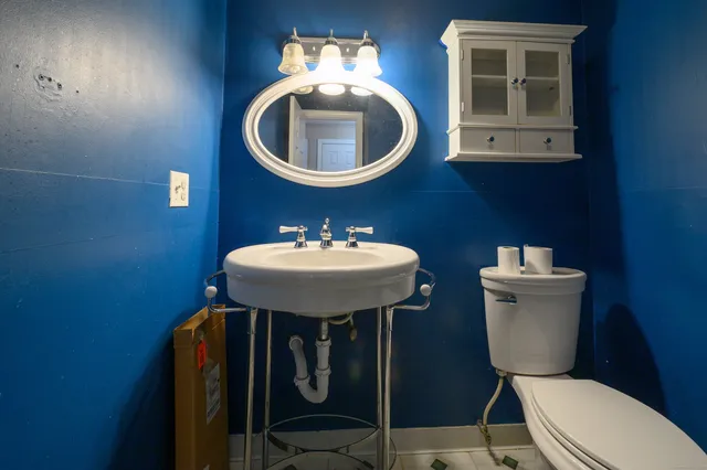 a view of a room with wooden floor and sink