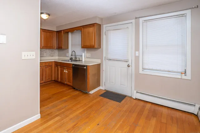 a kitchen with granite countertop a refrigerator and a sink