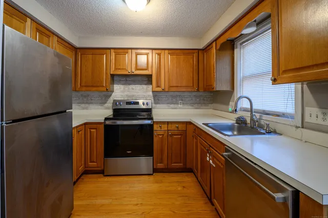 a kitchen with a sink stove and cabinets