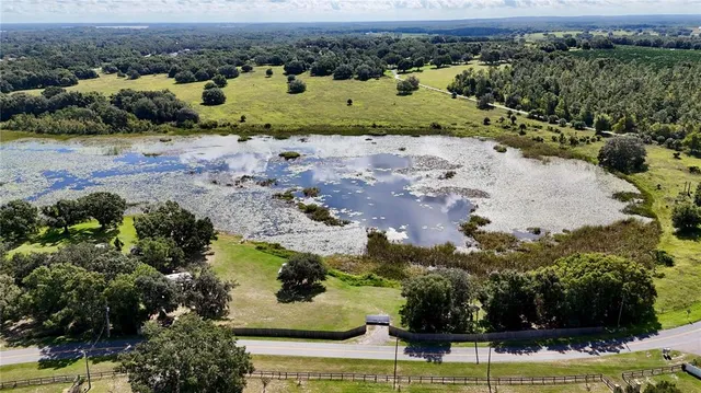 an aerial view of a houses with a yard