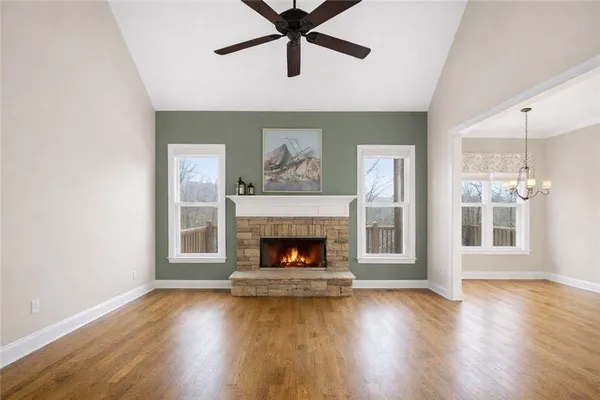 a living room with wooden floor and a fireplace
