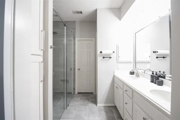 a bathroom with a double vanity sink mirror and double