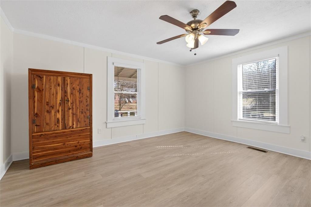 246 Spring Street Commerce, GA 30529 - Photo 16 of 23 an empty room with windows and ceiling fan
