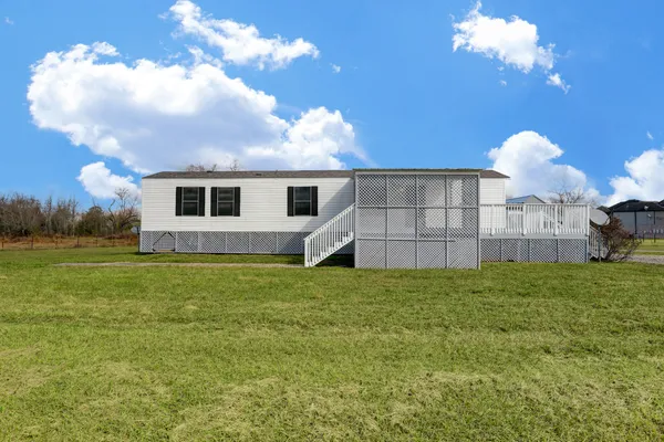 a view of a house with a backyard