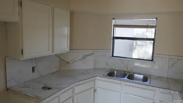 a bathroom with a sink and cabinets
