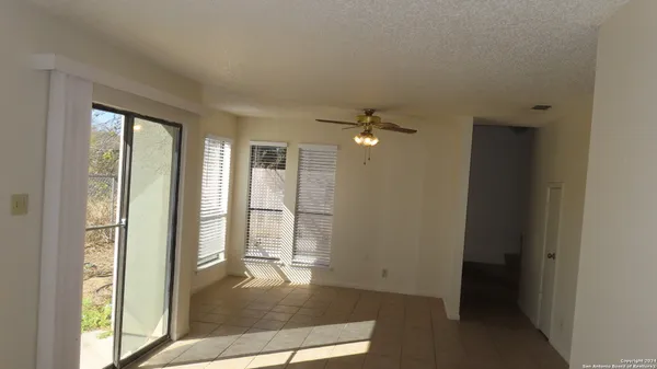 a view of an empty room with glass door