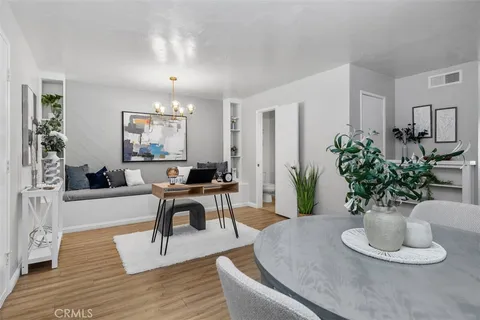 a living room with furniture potted plant and window