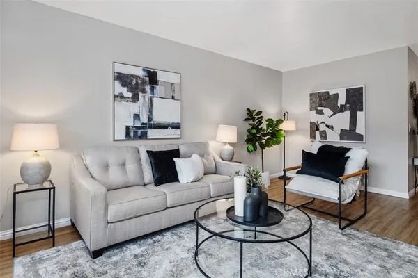 a living room with furniture a rug and a lamp