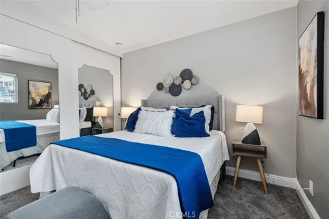 a bedroom with a bed and a lamp