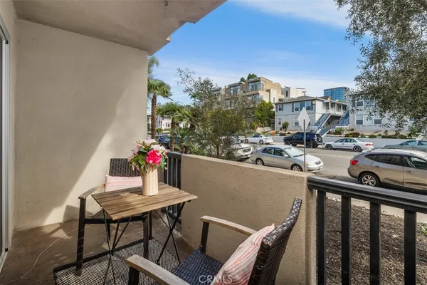 a balcony with table and chairs