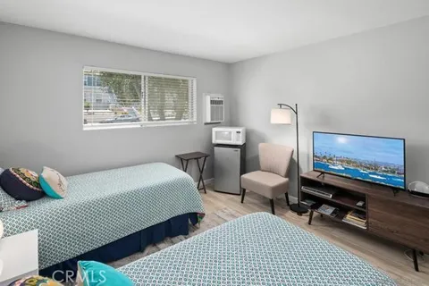 a bedroom with furniture and a flat screen tv