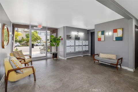 a view of a livingroom with furniture and a potted plant