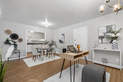 a view of a dining room with furniture and wooden floor