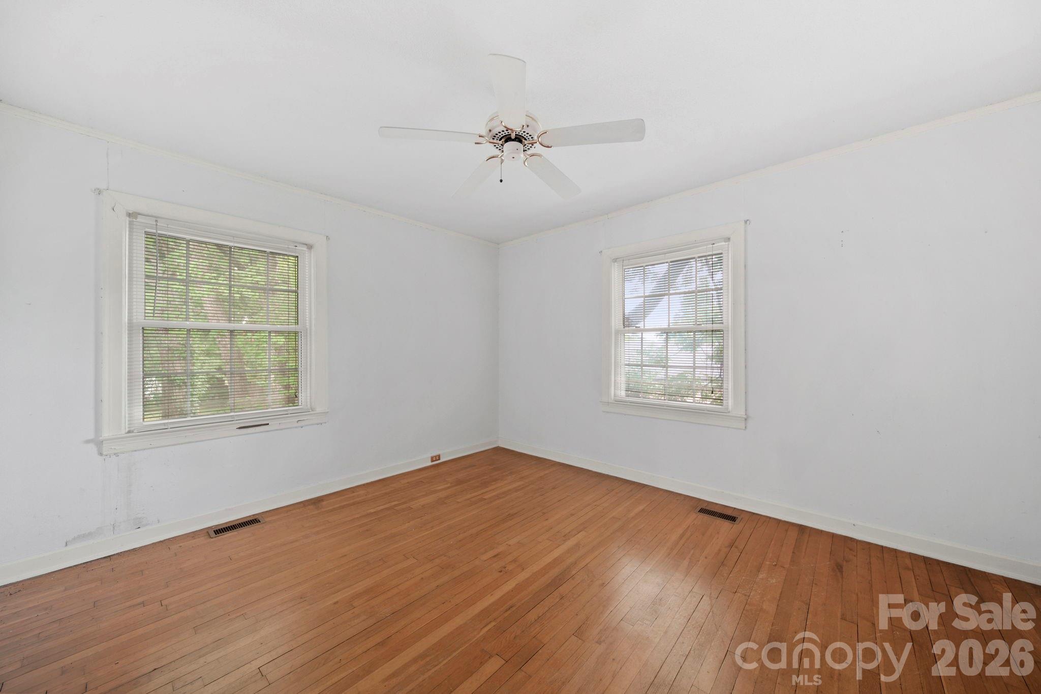 1109 Union Road Gastonia, NC 28054 - Photo 18 of 44 a view of an empty room with wooden floor and a window