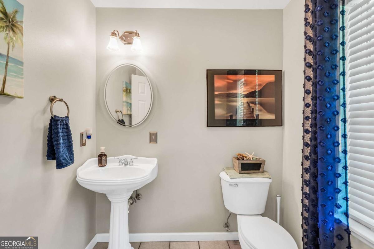159 County Line Road Locust Grove, GA 30248 - Photo 24 of 100 a bathroom with a toilet sink and mirror