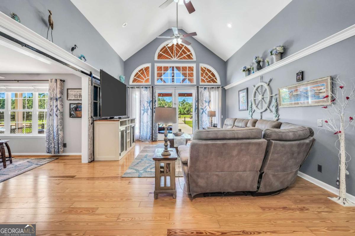 159 County Line Road Locust Grove, GA 30248 - Photo 30 of 100 a living room with furniture and a floor to ceiling window