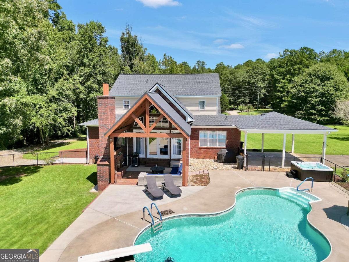 159 County Line Road Locust Grove, GA 30248 - Photo 3 of 100 a front view of a house with a yard table and chairs