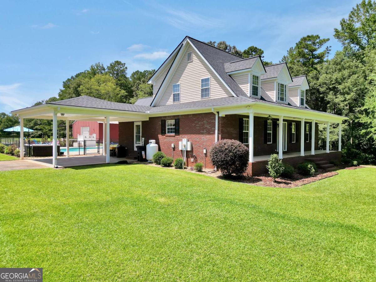159 County Line Road Locust Grove, GA 30248 - Photo 4 of 100 a view of a house with a yard table and chairs