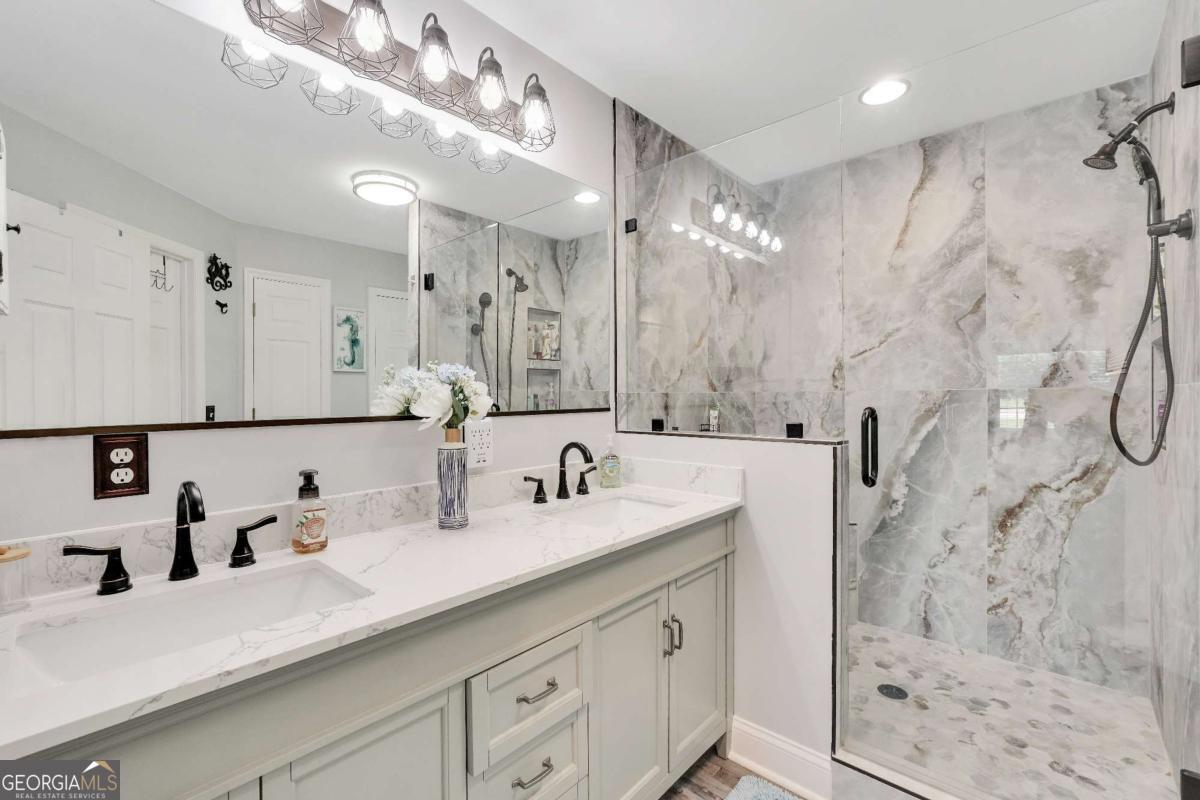 159 County Line Road Locust Grove, GA 30248 - Photo 45 of 100 a bathroom with a double vanity sink mirror and shower