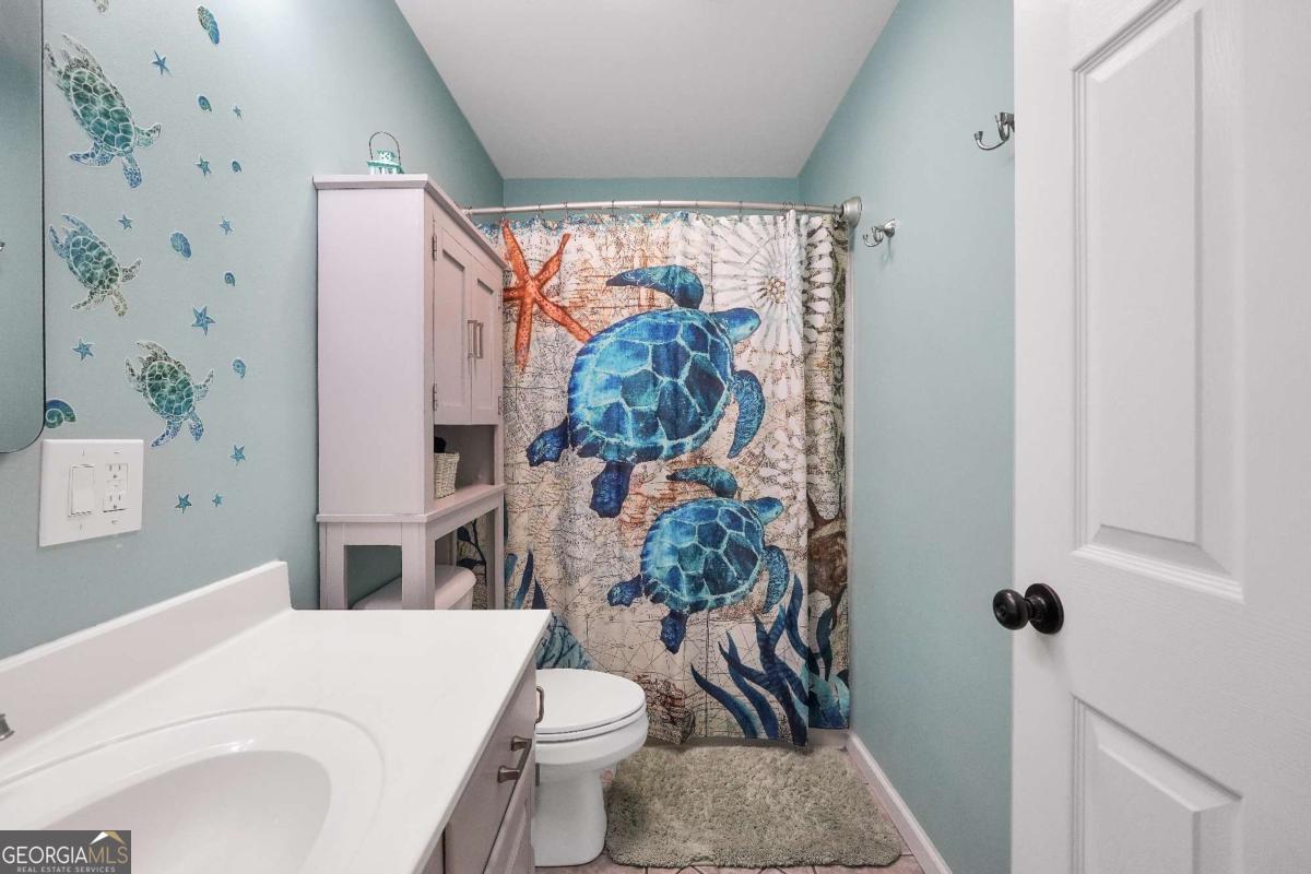 159 County Line Road Locust Grove, GA 30248 - Photo 51 of 100 a white toilet sitting next to a bathroom sink and a shower