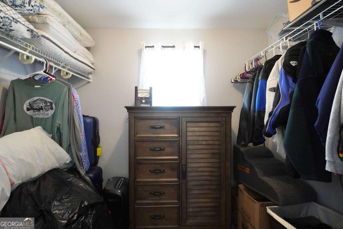 159 County Line Road Locust Grove, GA 30248 - Photo 56 of 100 a view of walk in closet with clothes and shoes