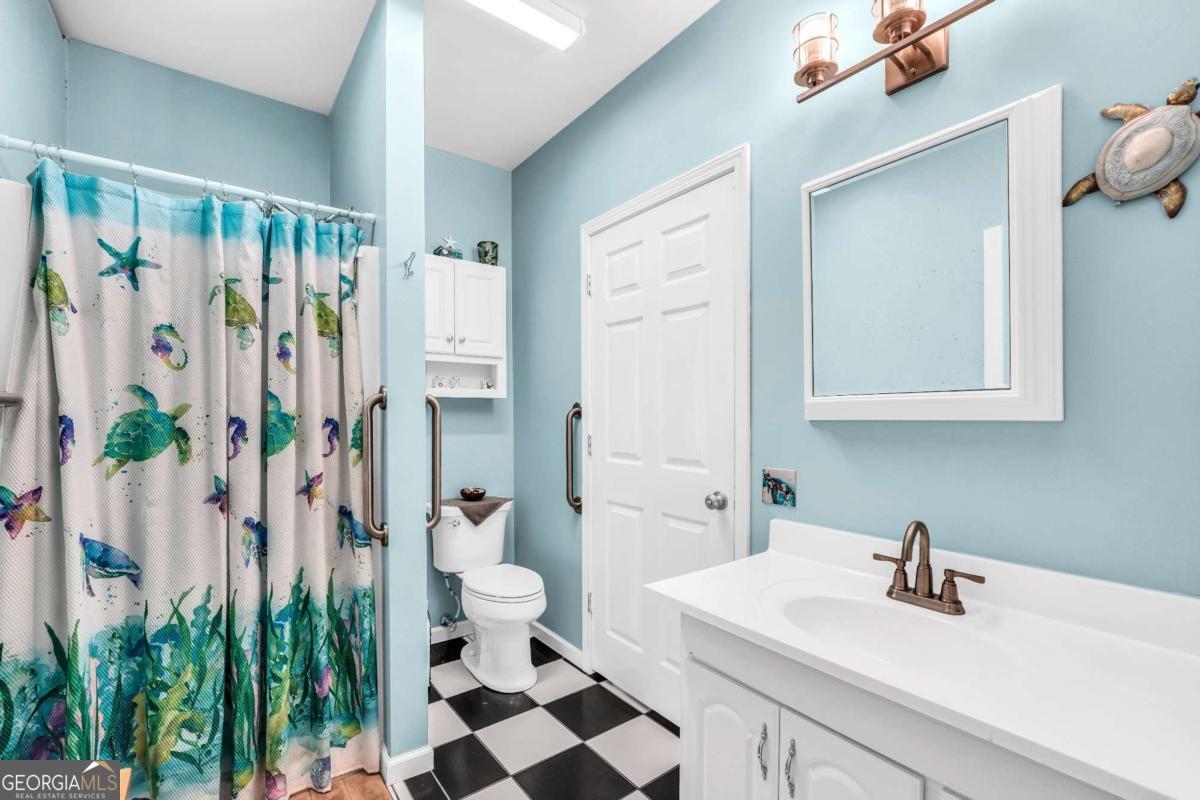 159 County Line Road Locust Grove, GA 30248 - Photo 59 of 100 a bathroom with a sink a toilet and a mirror