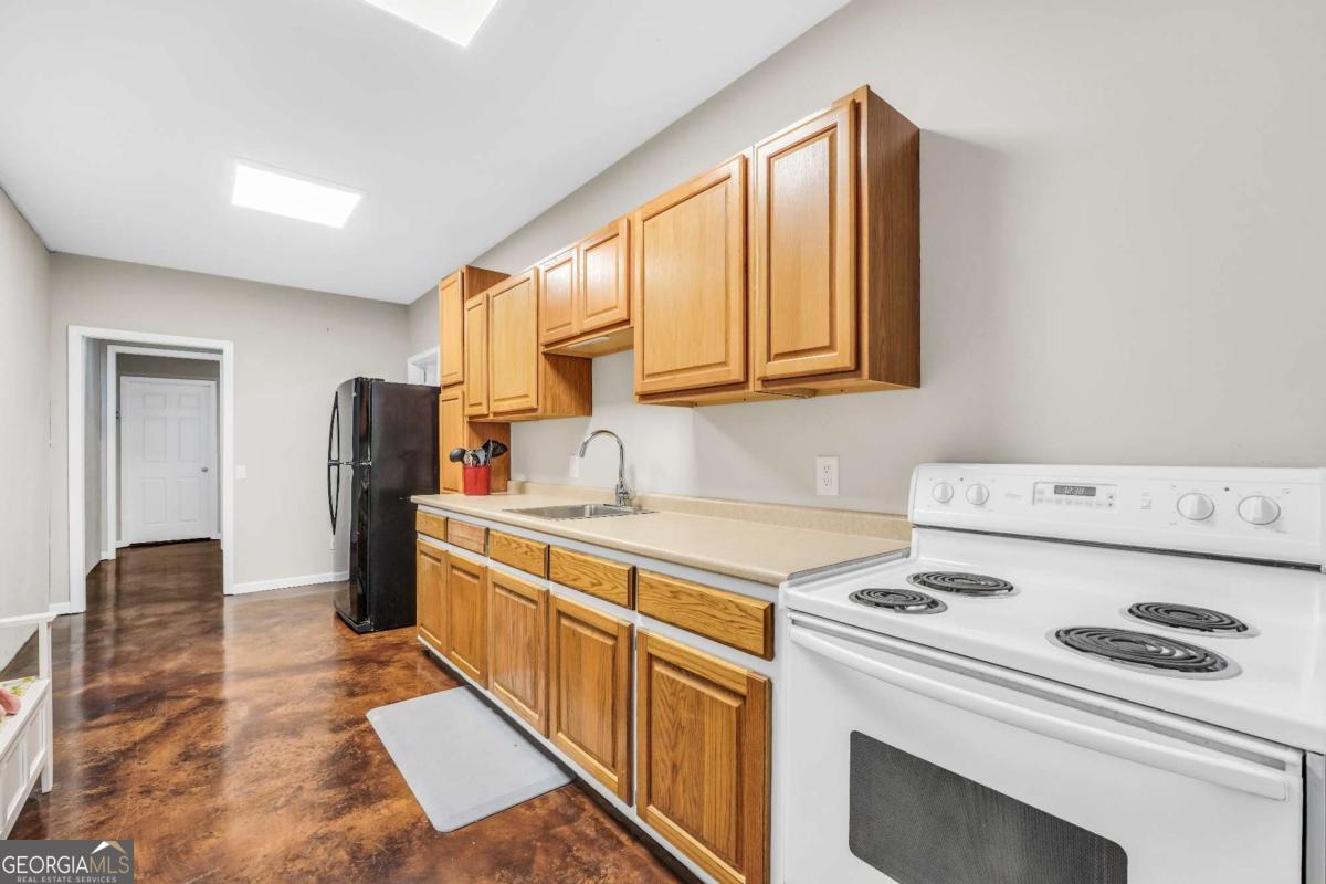 159 County Line Road Locust Grove, GA 30248 - Photo 63 of 100 a kitchen with a stove cabinets and a refrigerator