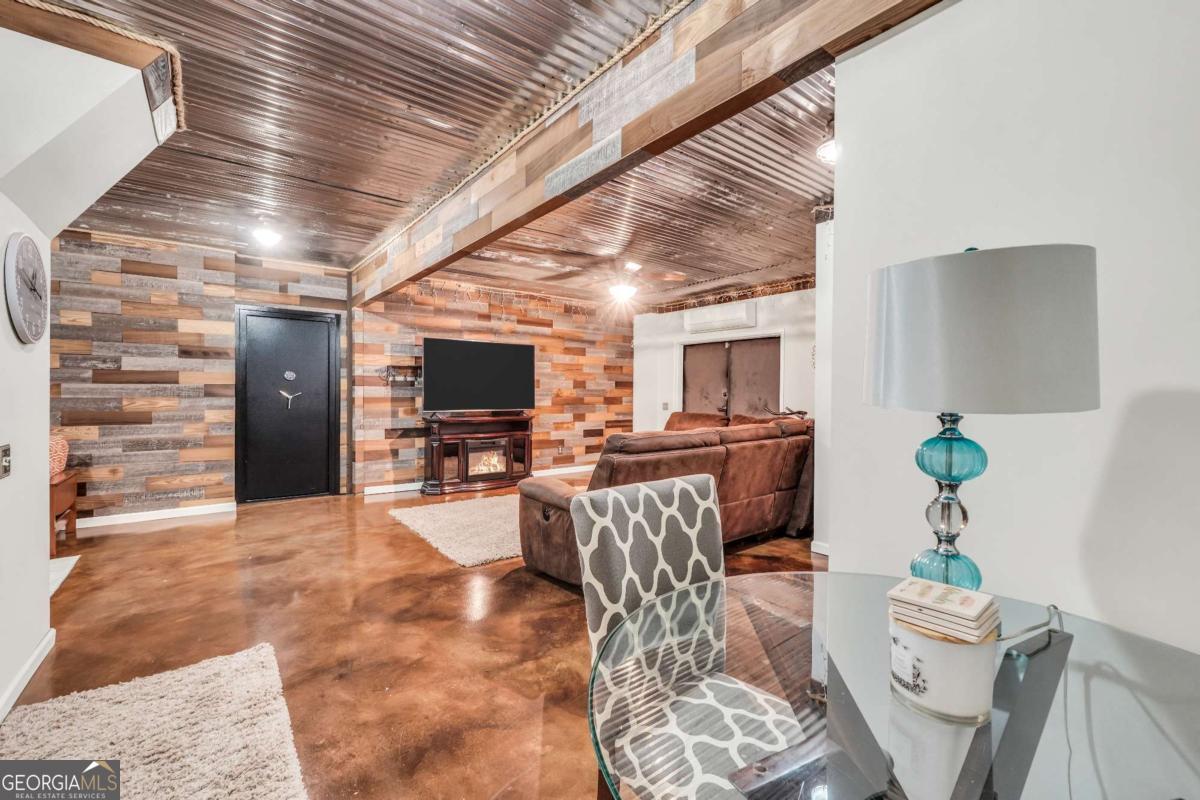 159 County Line Road Locust Grove, GA 30248 - Photo 65 of 100 a lobby with furniture and a flat screen tv