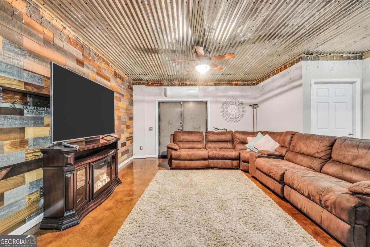 159 County Line Road Locust Grove, GA 30248 - Photo 67 of 100 a living room with furniture and a flat screen tv