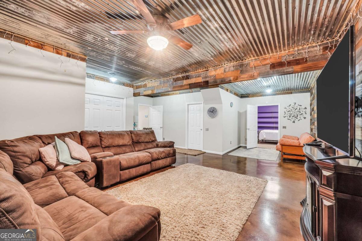 159 County Line Road Locust Grove, GA 30248 - Photo 69 of 100 a living room with furniture and a flat screen tv