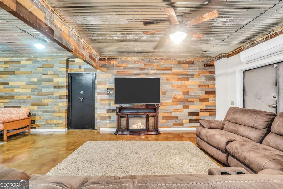 159 County Line Road Locust Grove, GA 30248 - Photo 70 of 100 a living room with furniture and a flat screen tv