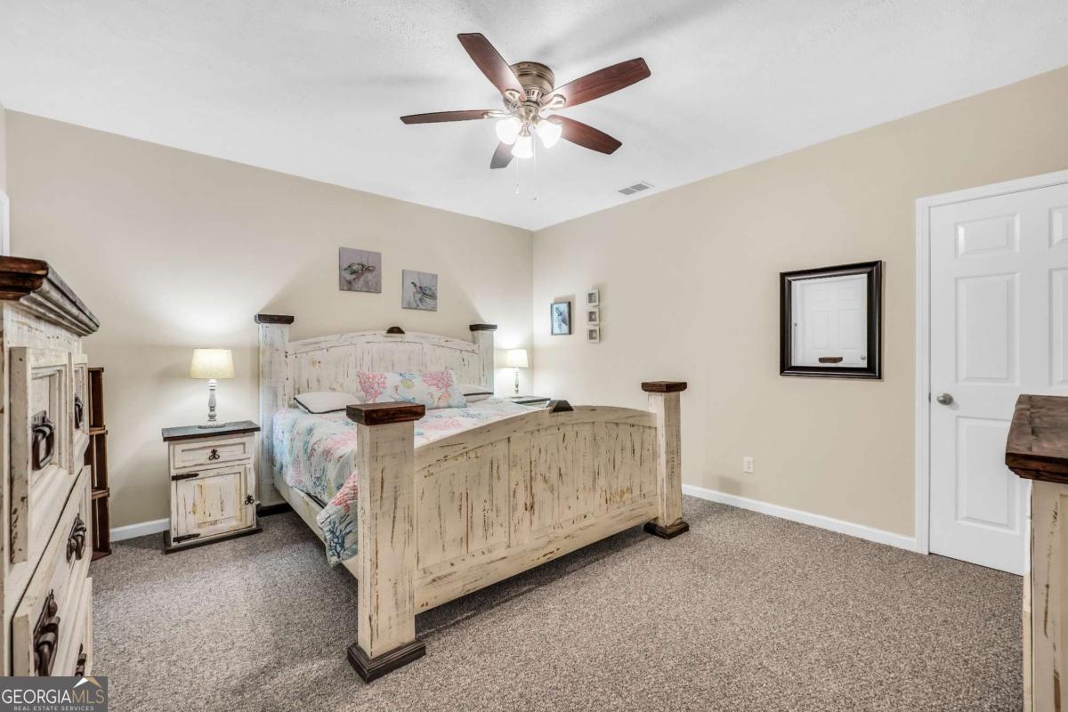 159 County Line Road Locust Grove, GA 30248 - Photo 80 of 100 a bed room with a bed and a ceiling fan