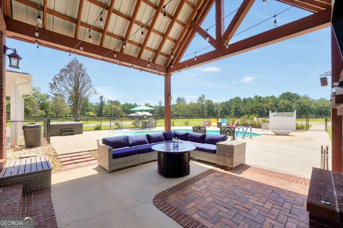159 County Line Road Locust Grove, GA 30248 - Photo 95 of 100 a view of a patio with couches dining table and chairs