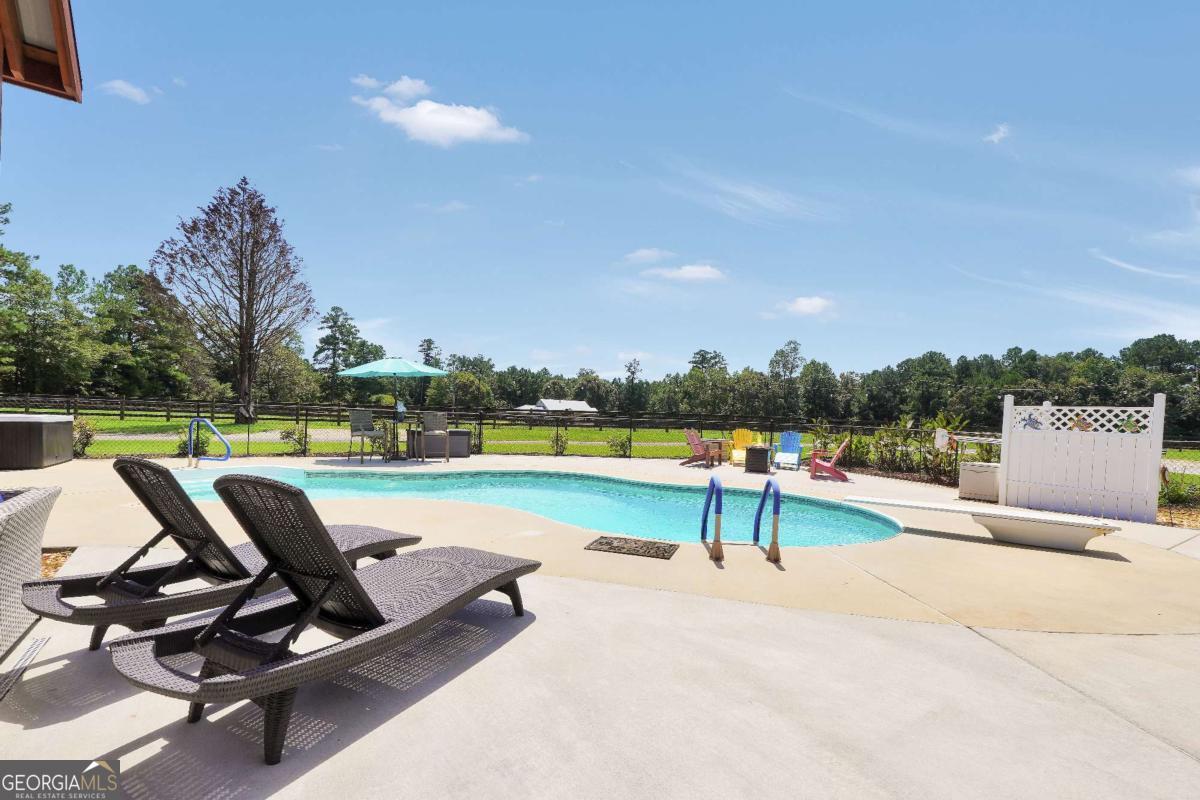 159 County Line Road Locust Grove, GA 30248 - Photo 96 of 100 a view of a swimming pool and lounge chairs in the terrace