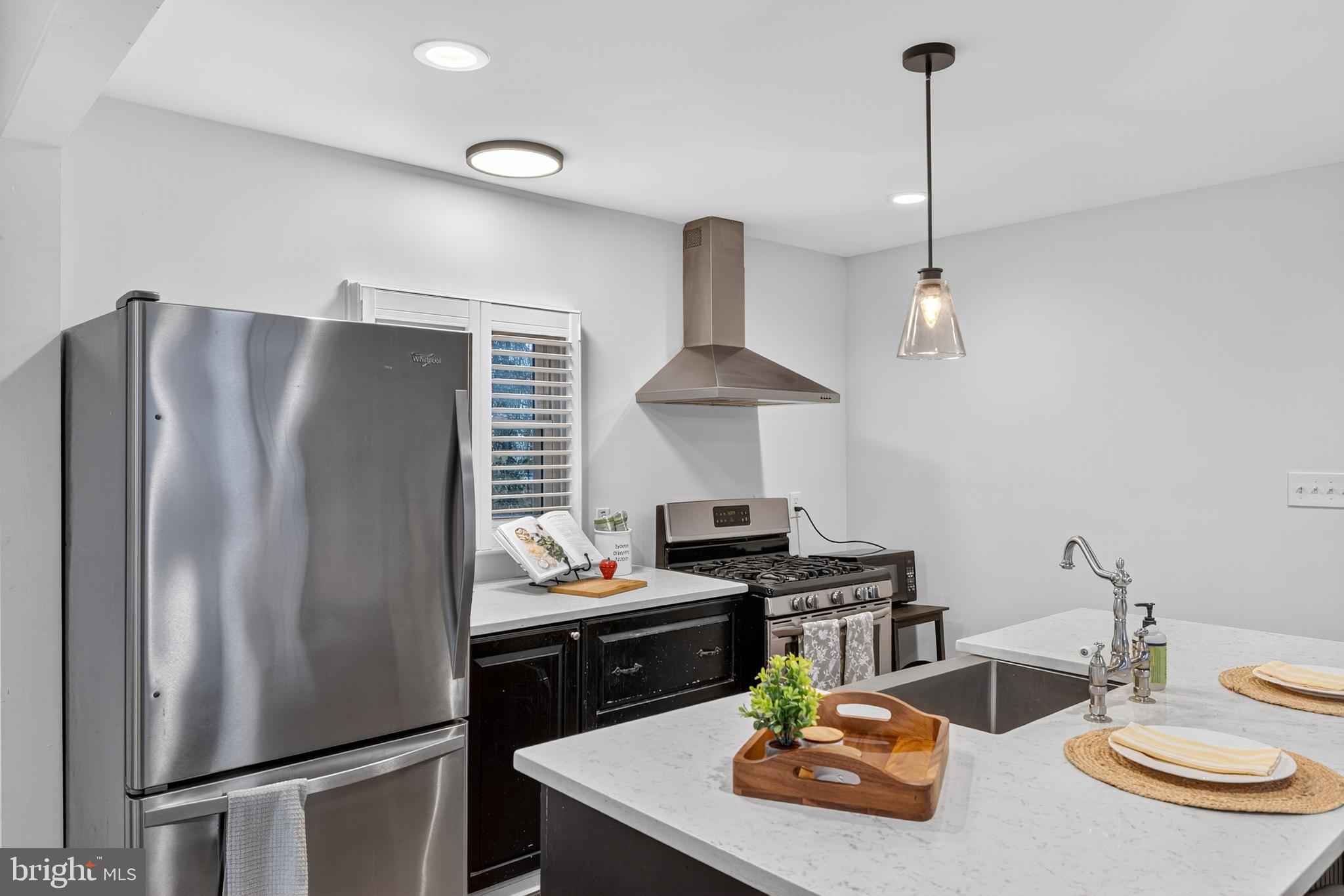 1424 Littlepage Street Fredericksburg, VA 22401 - Photo 14 of 34 a kitchen with stainless steel appliances a refrigerator a sink dishwasher a stove and a dining table