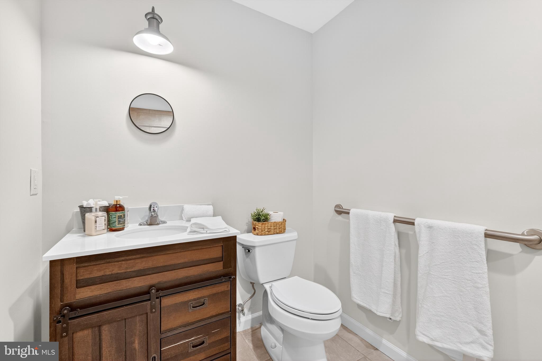 1424 Littlepage Street Fredericksburg, VA 22401 - Photo 22 of 34 a bathroom with a sink vanity and a toilet