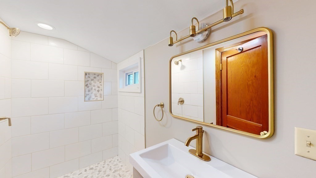 123 Pond Street Georgetown, MA 01833 - Photo 12 of 23 a bathroom with a sink a mirror and vanity