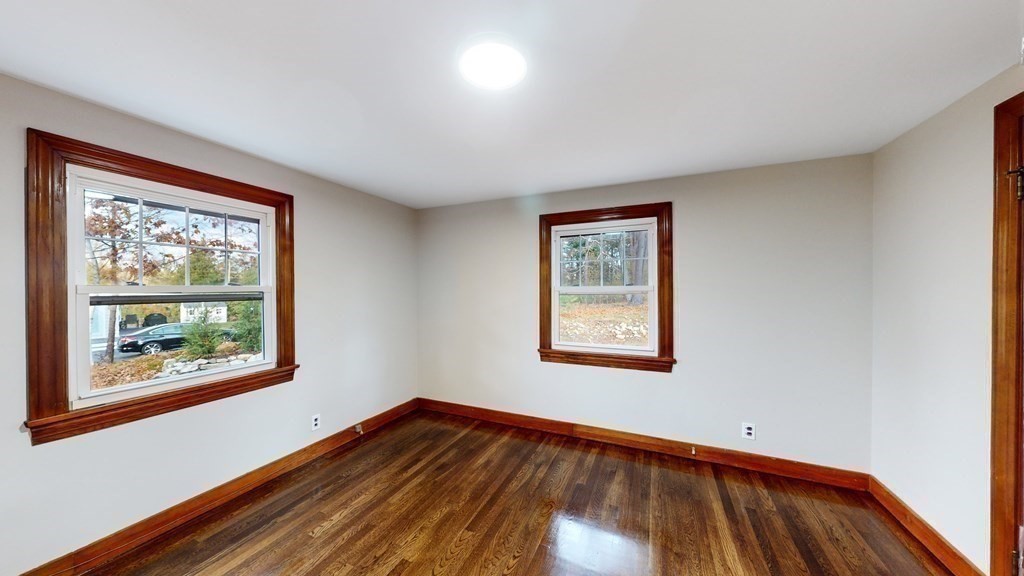 123 Pond Street Georgetown, MA 01833 - Photo 17 of 23 a view of an empty room with wooden floor and a window