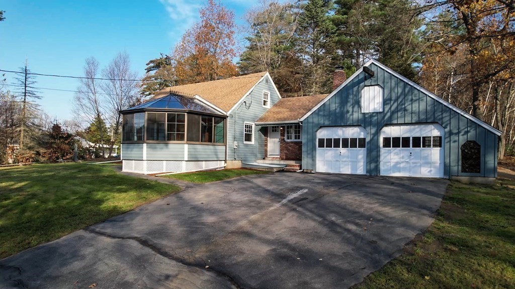 123 Pond Street Georgetown, MA 01833 - Photo 2 of 23 a front view of a house with a yard and garage