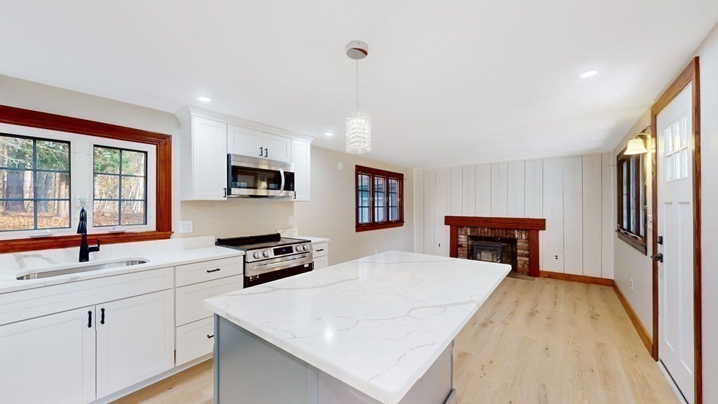 123 Pond Street Georgetown, MA 01833 - Photo 9 of 23 a kitchen with a refrigerator and a sink
