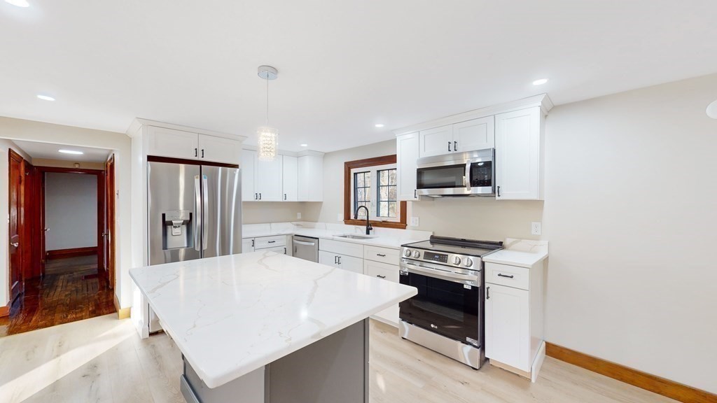 123 Pond Street Georgetown, MA 01833 - Photo 10 of 23 a kitchen with stainless steel appliances granite countertop a stove top oven a sink dishwasher and a refrigerator with wooden floor