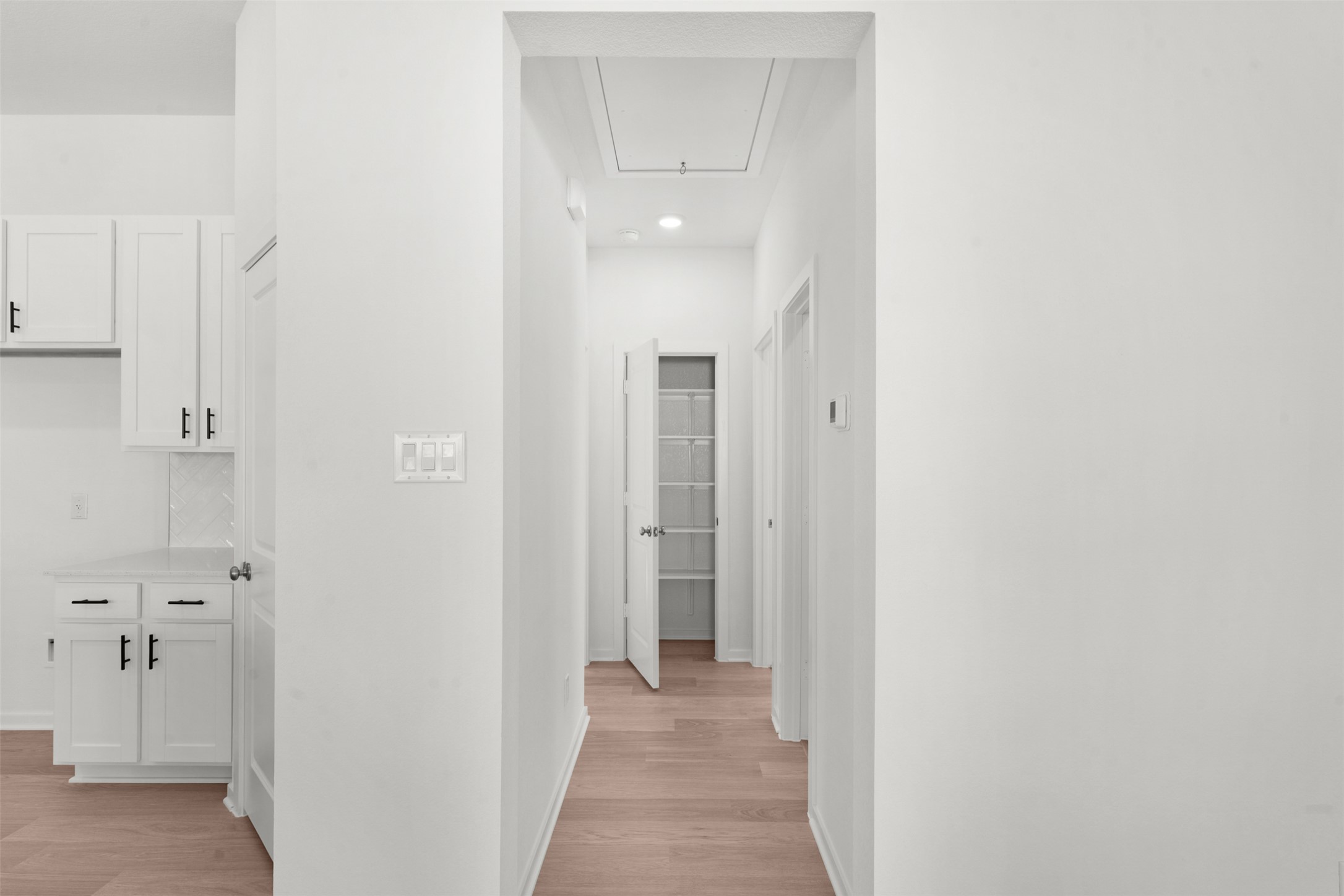 25601 Flora Bella Lane Elgin, TX 78621 - Photo 17 of 27 a view of a hallway with wooden floor