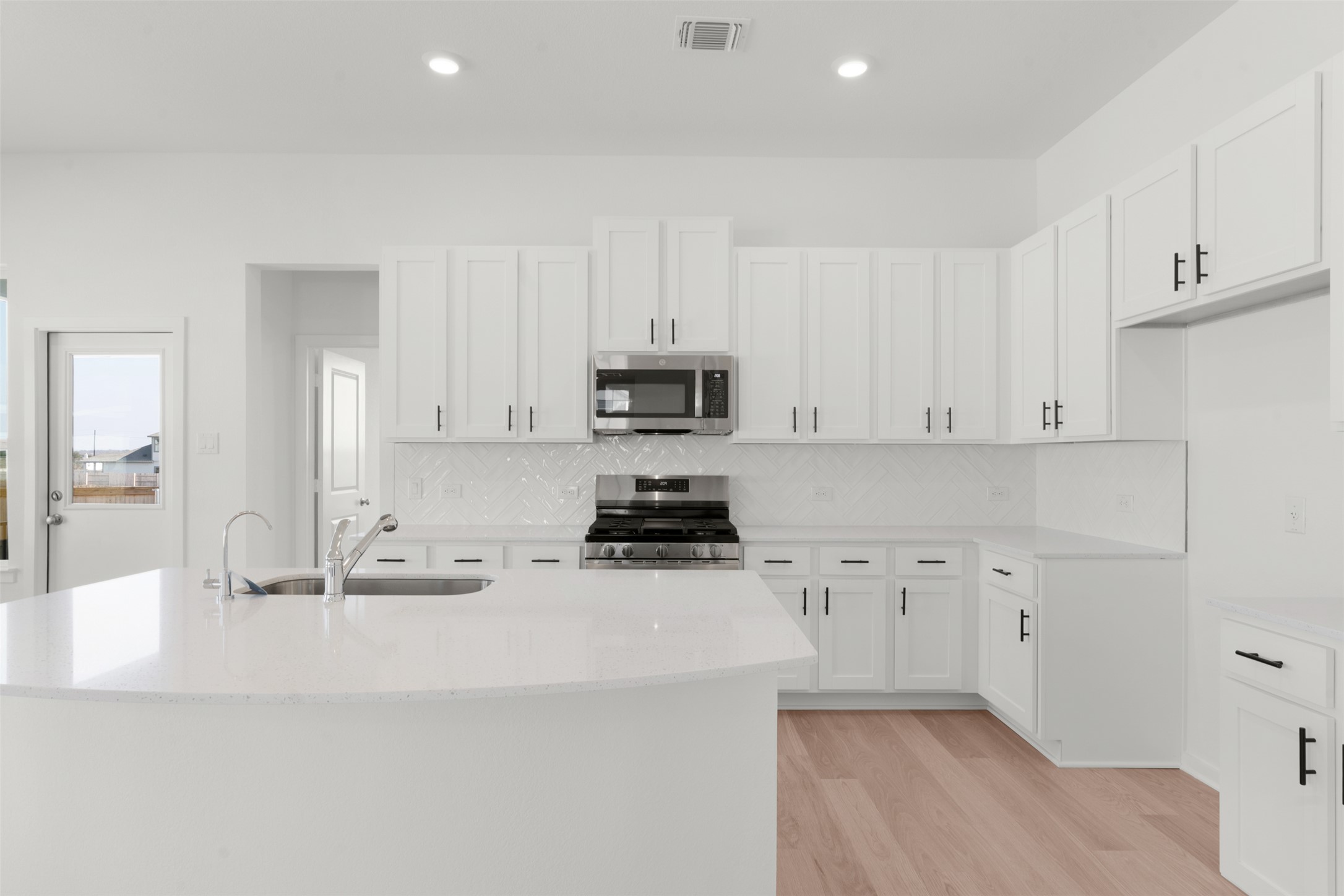 25601 Flora Bella Lane Elgin, TX 78621 - Photo 14 of 27 a kitchen with stainless steel appliances white cabinets and a sink