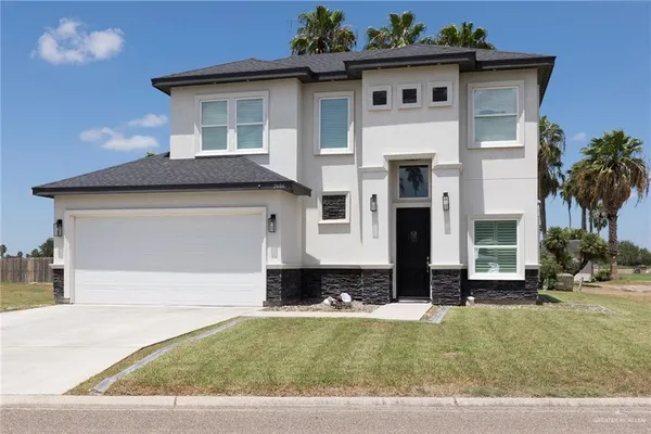 a front view of a house with a yard