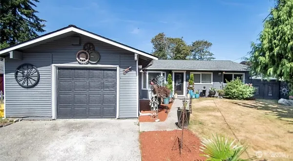 a front view of a house with a yard and garage