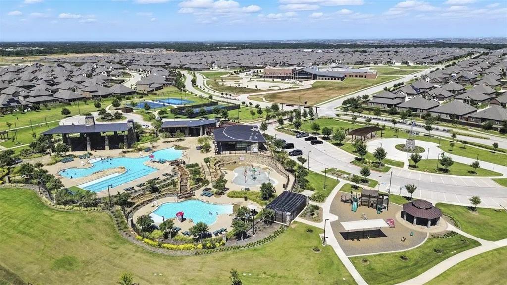 9828 Quail Pointe Road Aubrey, TX 76227 - Photo 22 of 23 Expansive community amenities including multiple swimming pools, a dedicated splash pad, tennis courts, and a playground